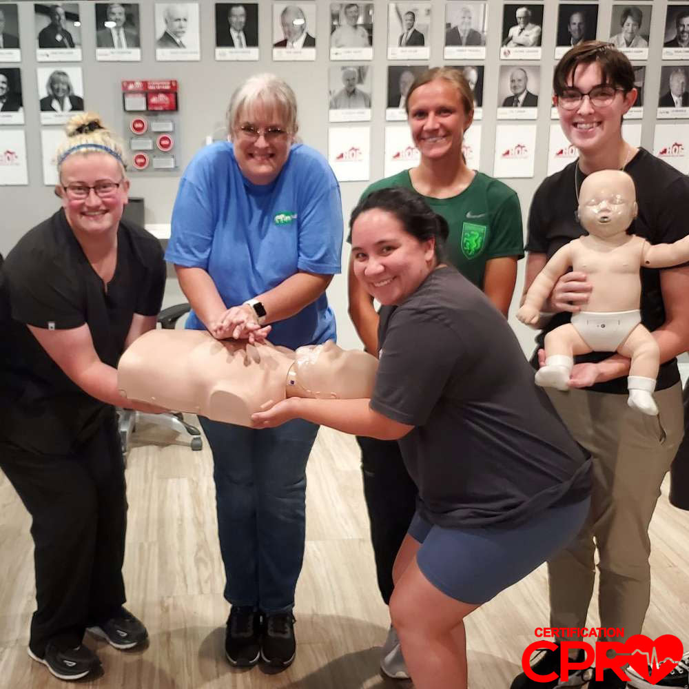 CPR training class in Arlington with students practicing on mannequins.